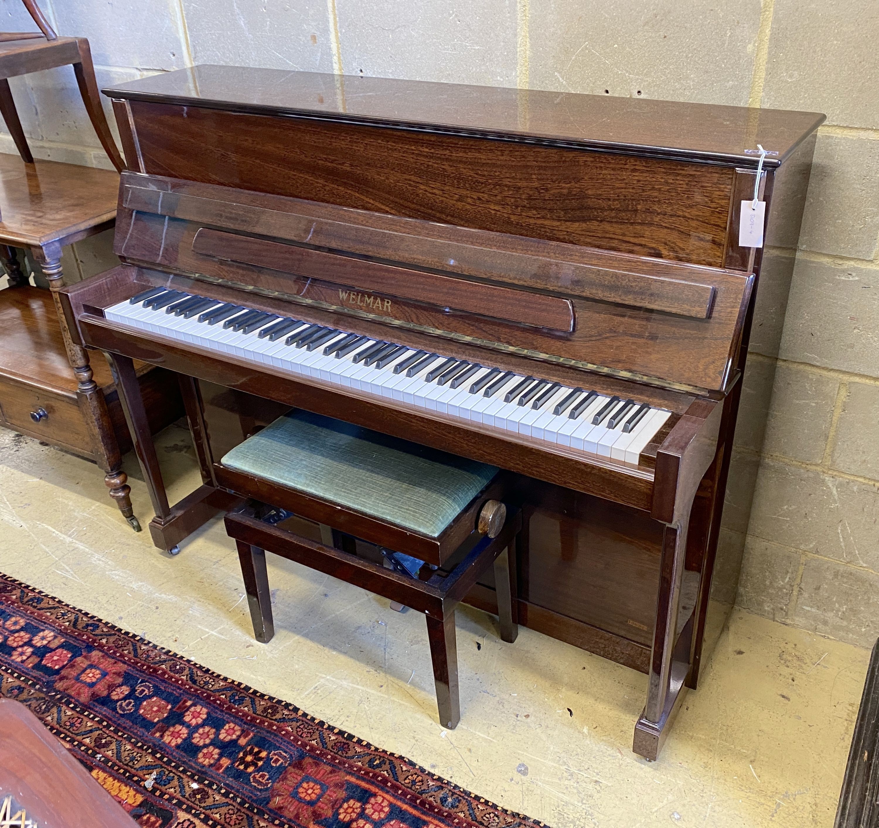 A Welmar mahogany cased upright piano and stool, circa 1986, piano - width 145cm, depth 57cm, height 117cm
